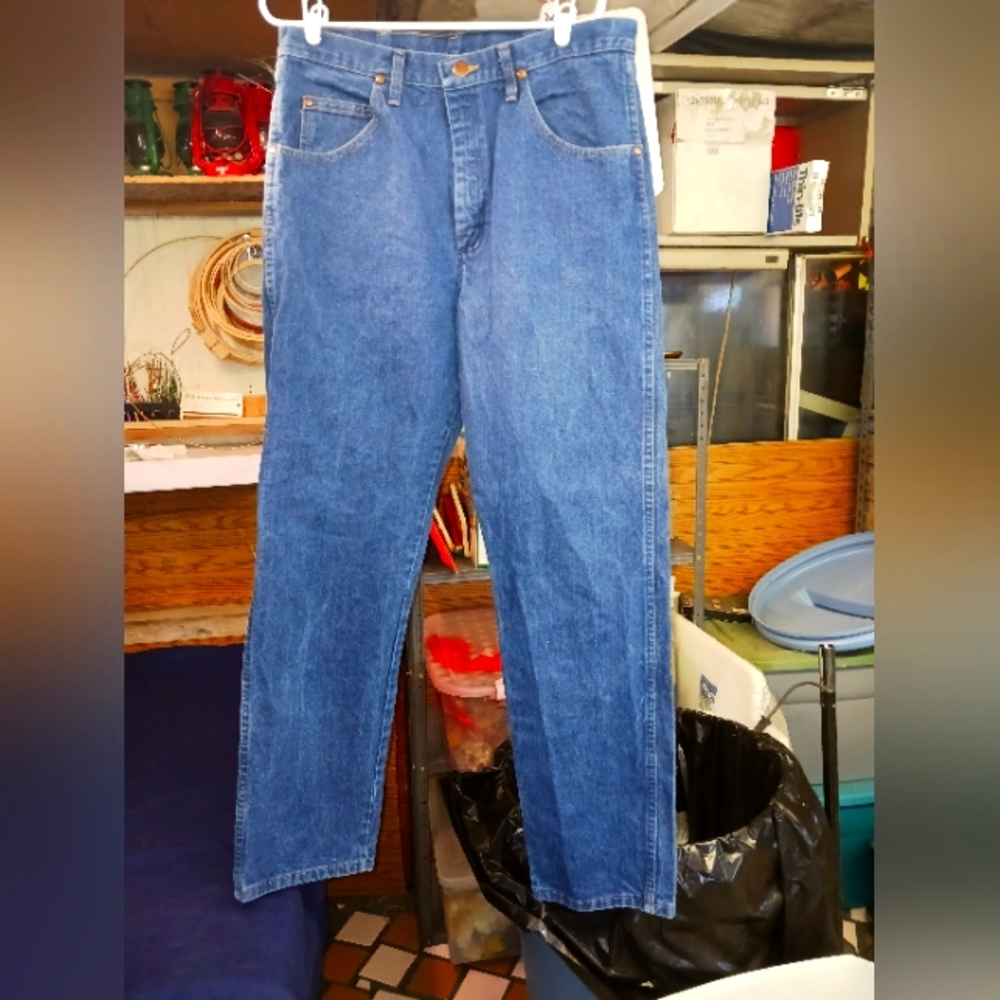 Men's Wrangler faded wash blue jeans.